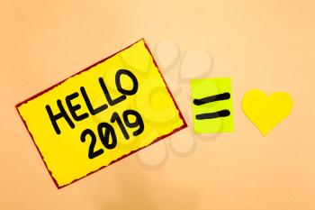 Conceptual hand writing showing Hello 2019. Business photo text Hoping for a greatness to happen for the coming new year Yellow paper reminder equal sign heart sending romantic feelings