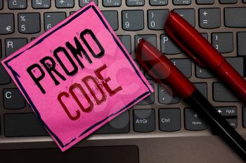 Writing note showing Promo Code. Business photo showcasing digital numbers that give you good discount on certain product Pink paper keyboard Inspiration communicate ideas messages Red markers