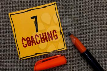 Conceptual hand writing showing 7 Coaching. Business photo showcasing Refers to a number of figures regarding business to be succesful Orange paper Marker Communicate ideas Jute background