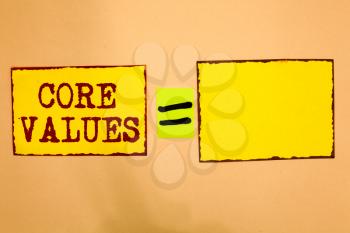 Conceptual hand writing showing Core Values. Business photo showcasing belief person or organization views as being importance Yellow paper notes reminders important messages to remember