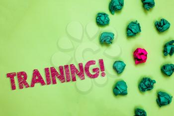 Text sign showing Training. Conceptual photo An activity occurred when starting a new job project or work Crumpled wrinkled papers one different pink unique special green background