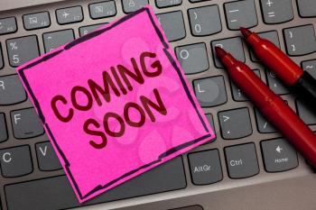Text sign showing Coming Soon. Conceptual photo something is going to happen in really short time of period Pink paper keyboard Inspiration communicate ideas messages Red markers