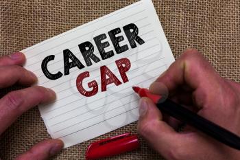 Writing note showing Career Gap. Business photo showcasing A scene where in you stop working by your profession for a while Man's hand hold white paper with symbolic letter jute sack background