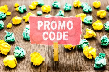 Word writing text Promo Code. Business concept for digital numbers that give you good discount on certain product Clothespin holding pink note paper crumpled papers several tries mistakes