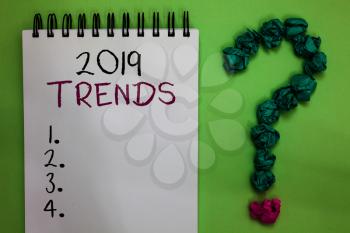 Text sign showing 2019 Trends. Conceptual photo things that is famous for short period of time in current year Open notebook crumpled papers forming question mark green background
