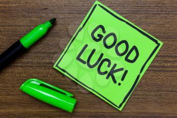 Conceptual hand writing showing Good Luck. Business photo showcasing A positive fortune or a happy outcome that a person can have Green Paper Communicate ideas Marker Wooden background