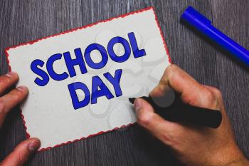 Writing note showing School Day. Business photo showcasing starts from seven or eight am to three pm get taught there Man holding marker paper red borders express ideas Wooden background