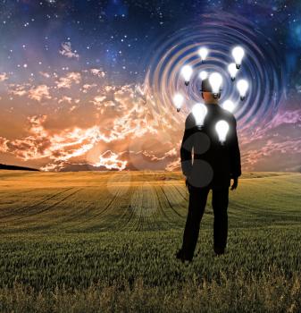Surreal landscape with man and idea bulbs