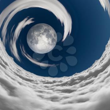 Big full moon in a vortex of clouds