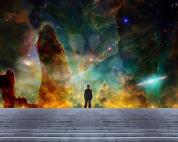 Man in black suit stands before vivid space