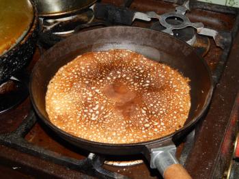 Pancakes on a new cast-iron skillet on Shrovetide