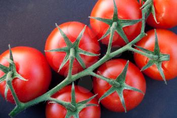 Close-up of some ripe tomatoes on the vine