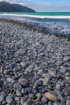 Beach near Mangamaunu strewn with small grey boulders