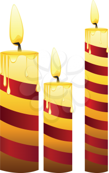 Set of lit candles in different sizes.