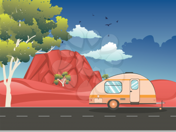 Vintage camping trailer on the road in the red desert landscape.
