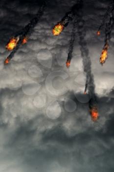 Grunge fireballs with smoke tails over cloudy background.