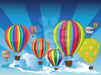 Group of hot air balloons on the blue sky with clouds.