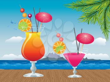 Two glasses of tropic cocktail on wooden table background.