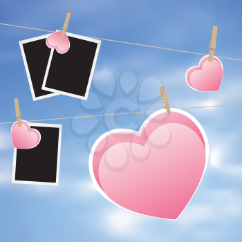 Retro photo frame and hearts on a rope with pegs.