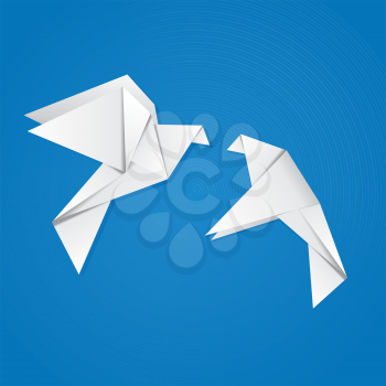 Two white origami pigeons on blue background.