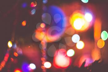 Decorated Christmas tree and colorful garland lights, defocused background, bokeh.