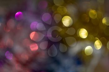 Defocused decorative Christmas tinsel as background with bokeh effect.
