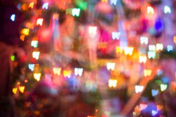 Festive background with butterfly shaped bokeh from Christmas tree lights glowing. 