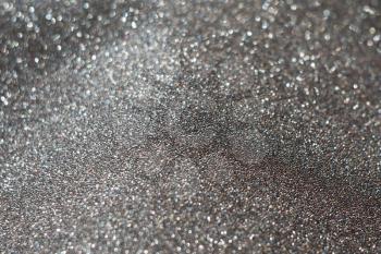 Decorative grey glitter texture macro, defocused background, bokeh.