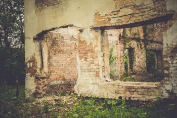 Old destroyed an abandoned house with brick walls, filtered background.