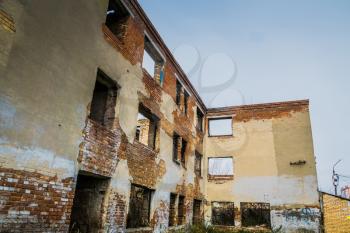 Old crumbling brick house, abandoned building background.