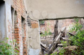 Old destroyed an abandoned house with grunge brick walls.