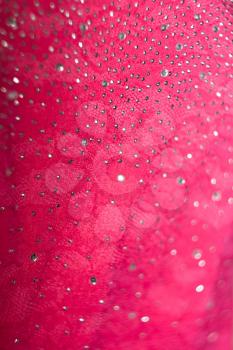 Bright pink background with circular bokeh effect.