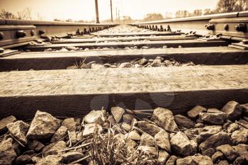 Grunge old railroad tracks close up background.