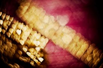 Colorful blurred background of pink and gold color, bokeh effects, textured with paper.