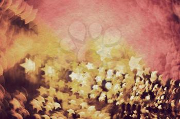 Colorful blurred background of pink and gold color, bokeh effects, textured with paper.