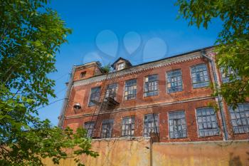 Abandoned old factory from red bricks in countryside.