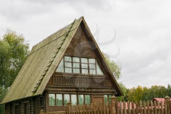Traditional rural architecture, vintage wooden house and fence.