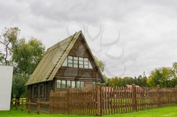 Traditional rural architecture, vintage wooden house and fence.