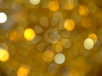 Abstract golden blurred background with bokeh effect.