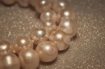 Beaded bracelet made of fresh water pearls, filtered background.