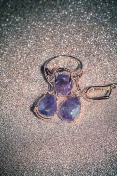 Fashion rose gold earrings and ring made of natural purple amethyst gemstone.