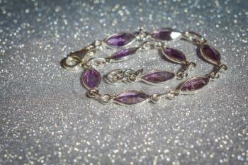 Fashion silver bracelet decorated with natural amethyst gemstone.