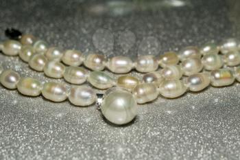 Natural white freshwater pearl necklace close up background.