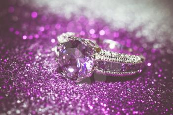Fashion silver ring with purple zirconia, amethyst imitation, filtered.