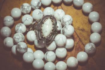 Beads with natural stone white turquoise close up filtered background.