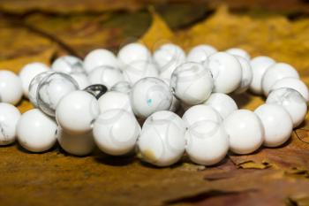 Beads with natural stone white turquoise close up background.