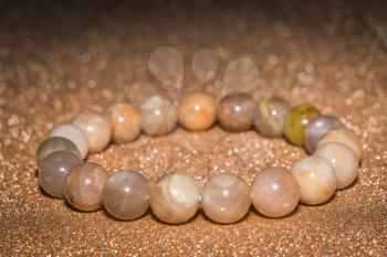 Brown moonstone or sunstone boho beaded bracelet close up. 