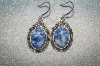Decorative silver earrings with sodalite, blue white spotted stone.