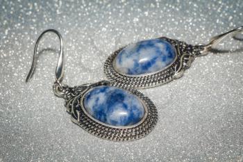 Decorative silver earrings with sodalite, blue white spotted stone.