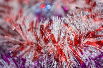 Colored decorative Christmas tinsel texture as holiday background.